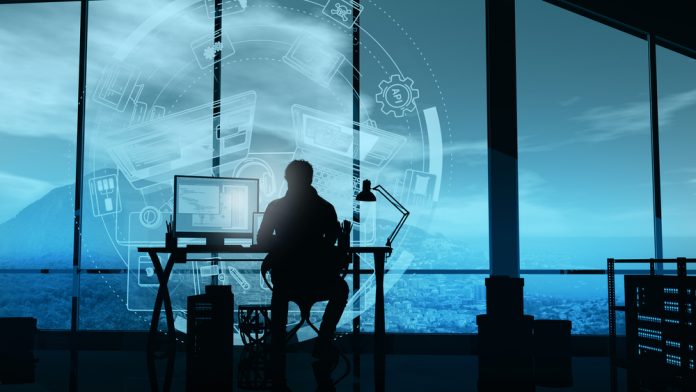 The web developer works in his office on the infographics background.